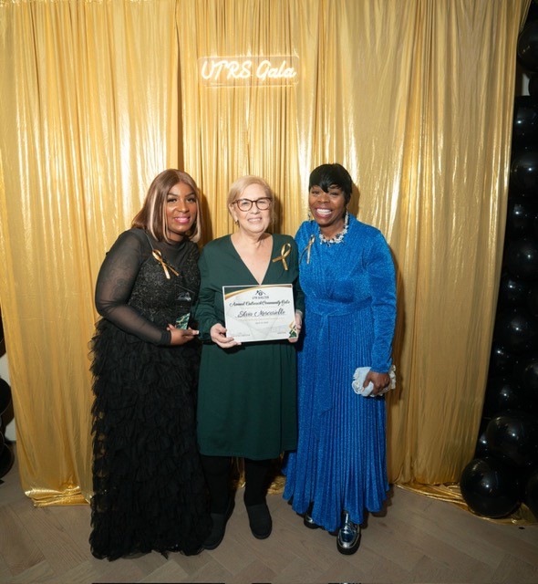 An award presentation at the Annual Outreach Community Gala