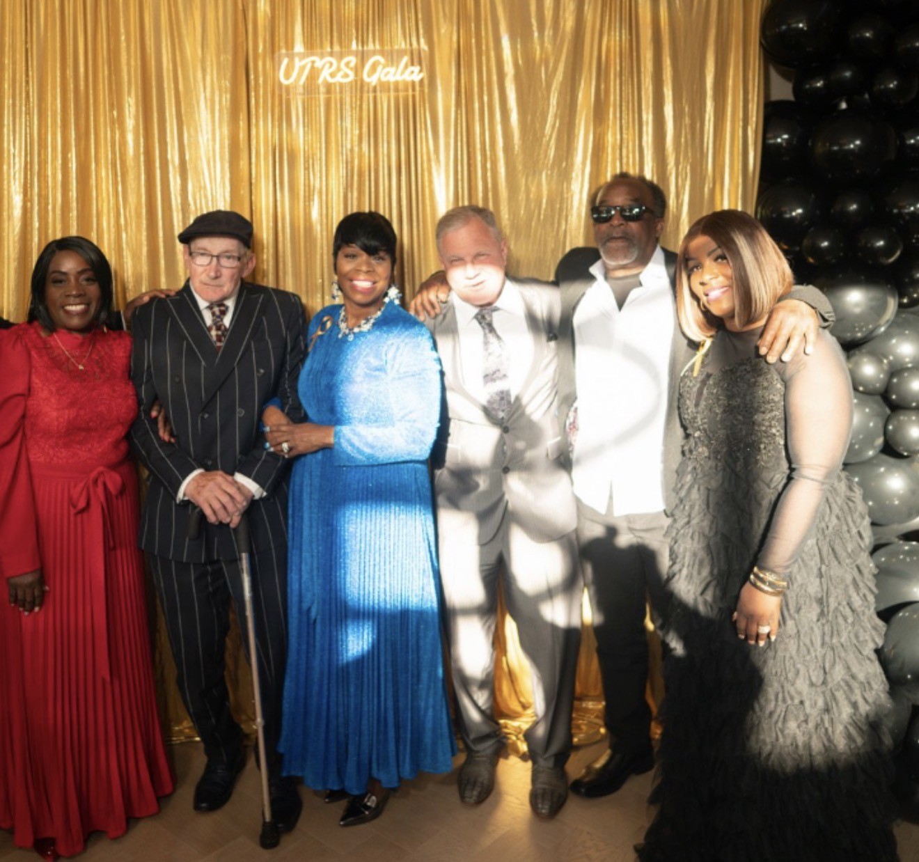 Group photo of Gala attendees in front of the UTRS Gala backdrop