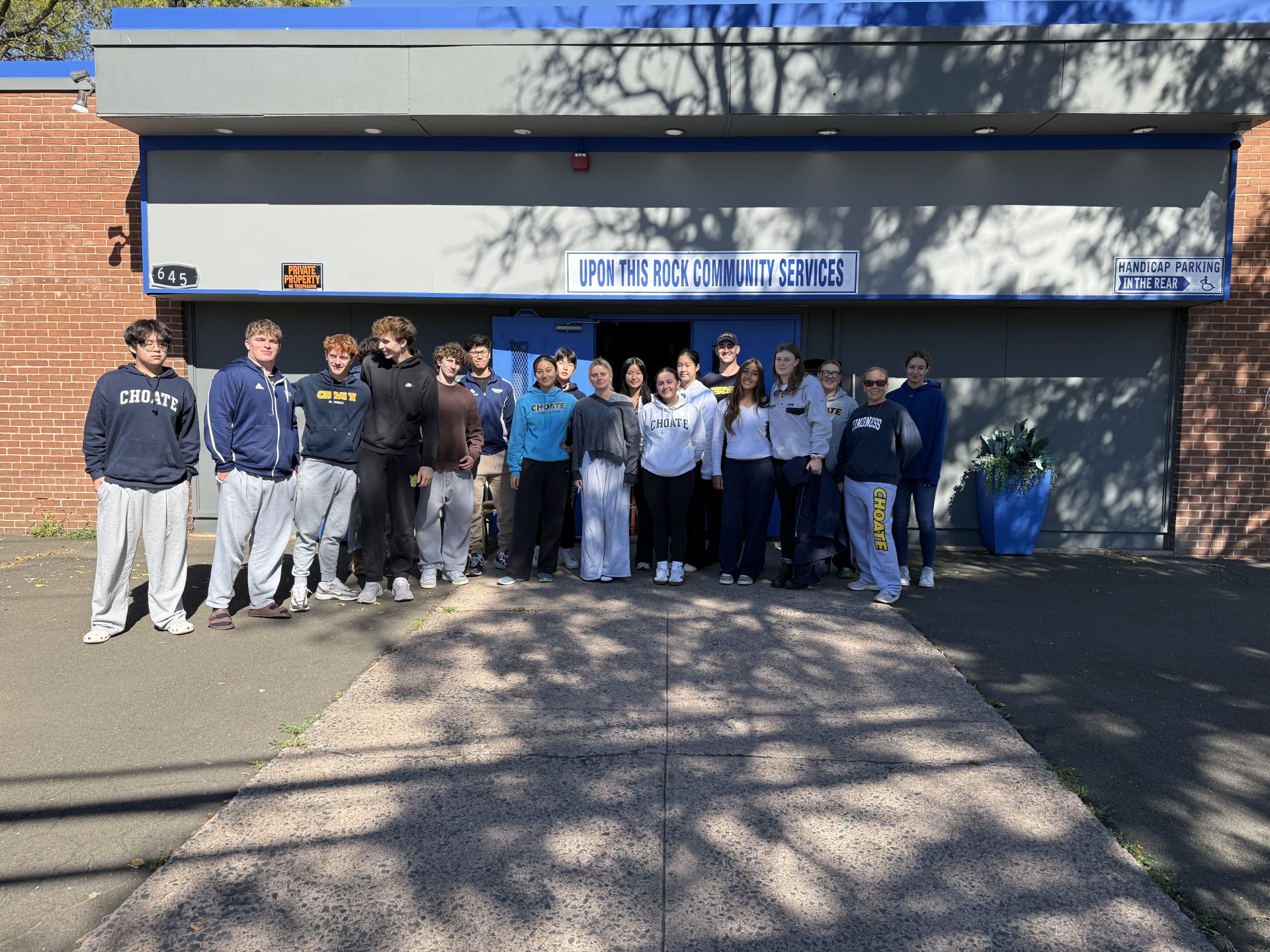 Student volunteers gathered outside the Upon This Rock Community Services entrance in New Haven